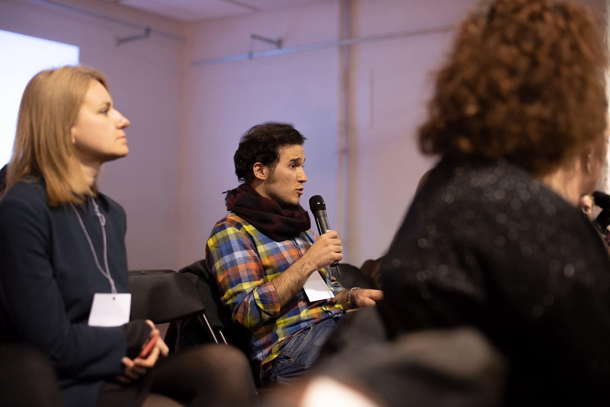 Sepehr Sharifzadeh speaking during a professional arts gathering